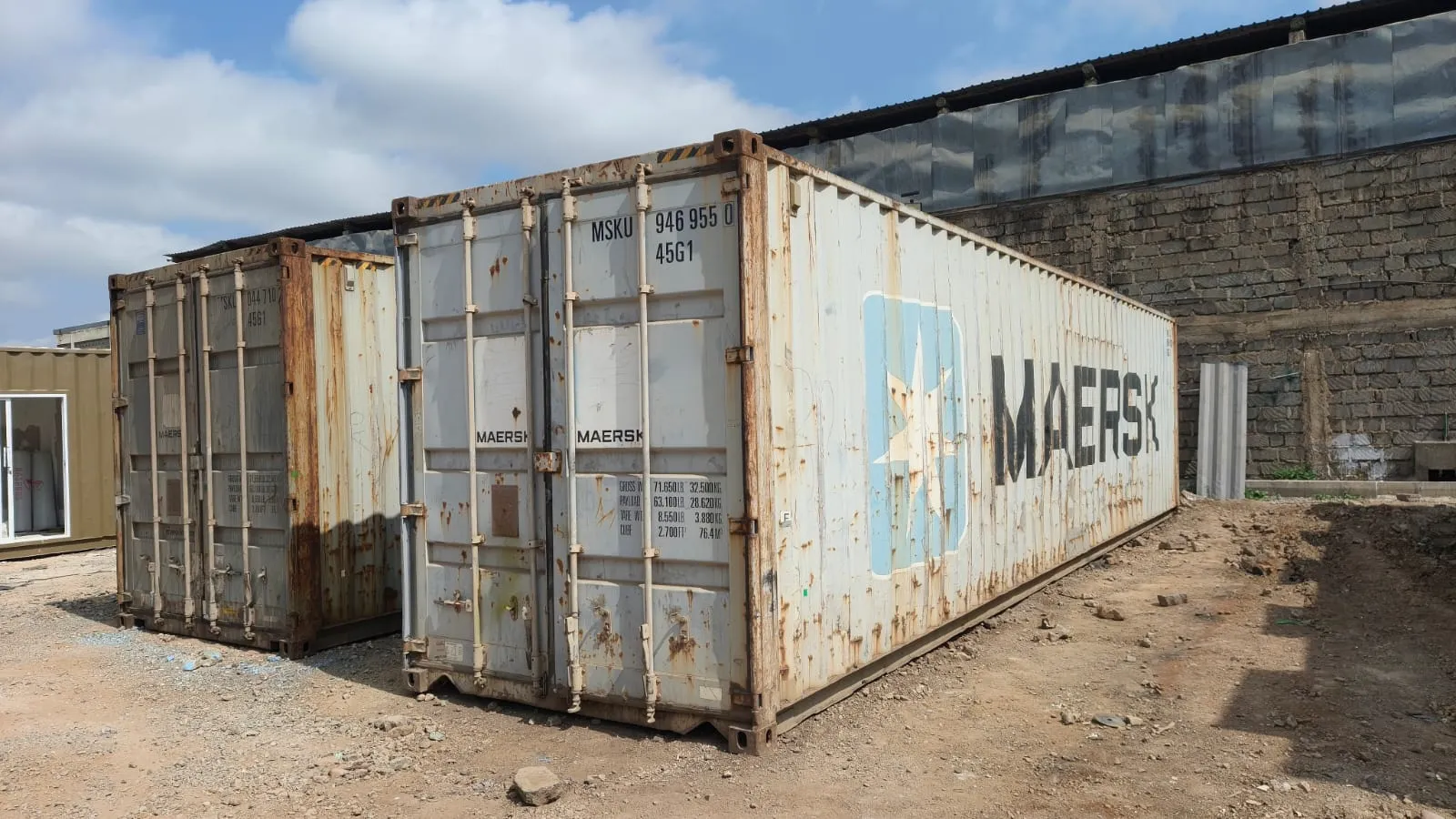 Two used shipping containers standing in the yard